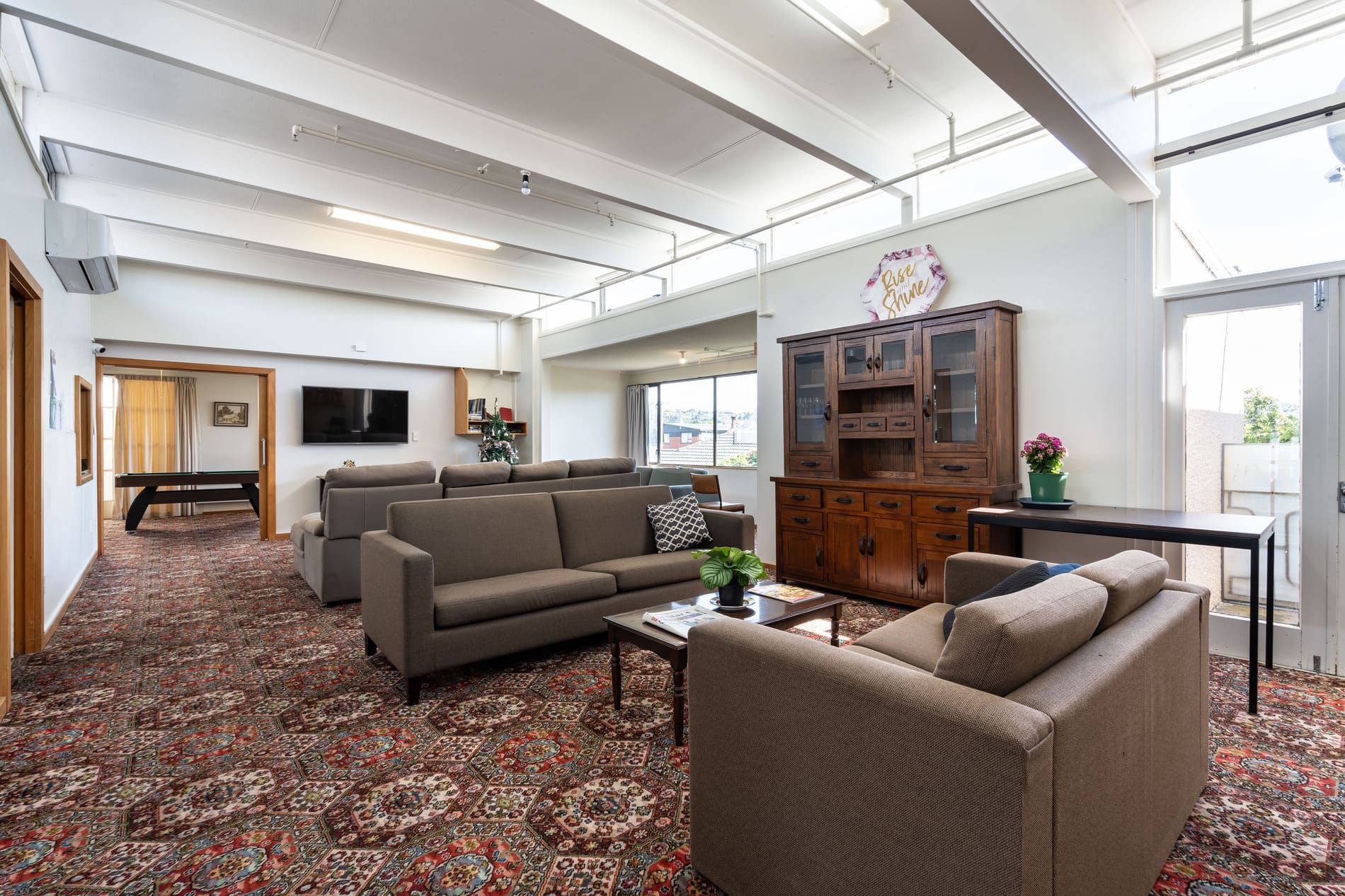 Shared lounge at Nine on Mitchell with sofas, smart TV and heat pump
